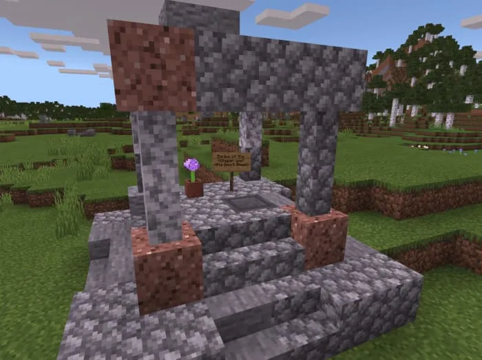 Колодец с табличкой и цветком