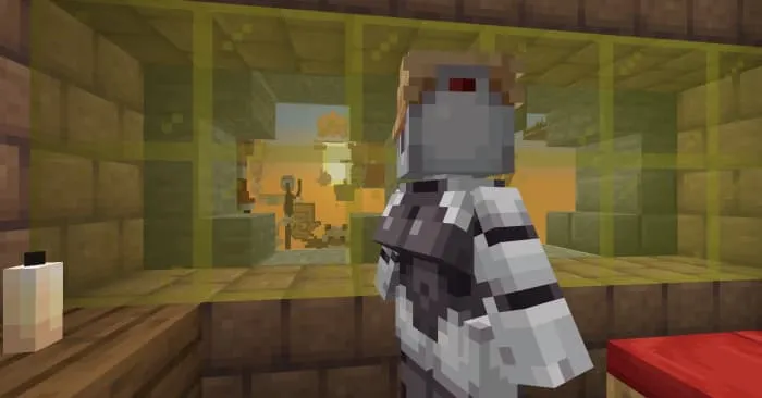 Робот серых оттенков на фоне желтого стекла и заката