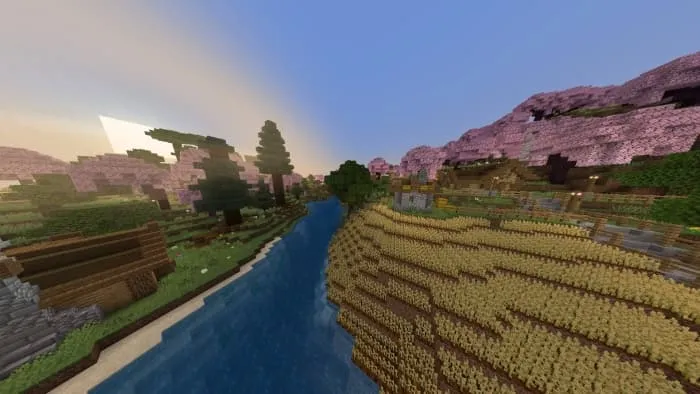 Поле пшеницы и дома у реки